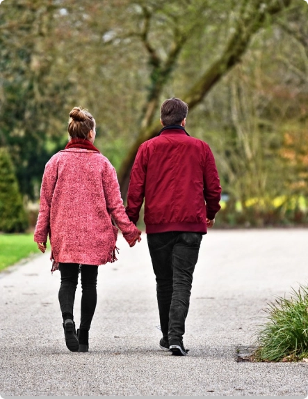 a couple walking and holding hands
